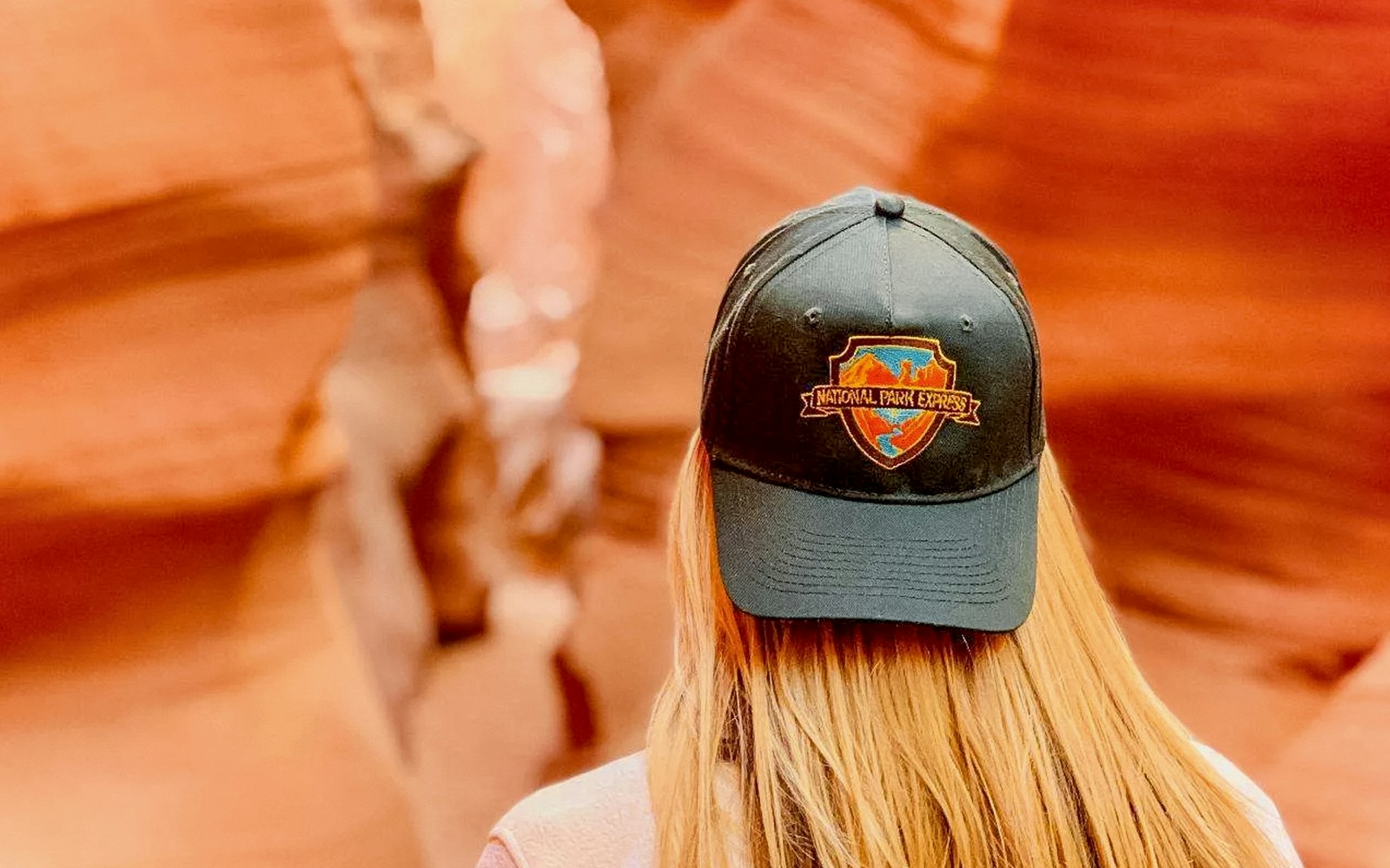 Visitor wearing a National Park Express cap in Antelope Canyon.