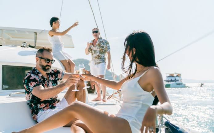 Adults enjoying drinks on a sailboat in Tenerife.