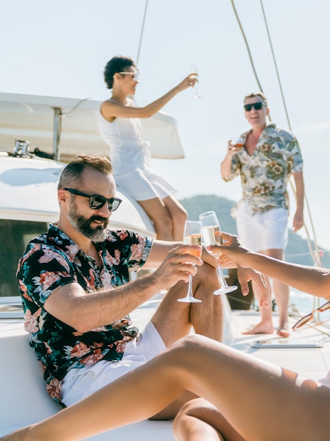 Adults enjoying drinks on a sailboat in Tenerife.