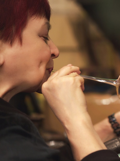 Glassblower shaping glass at Murano factory demonstration.