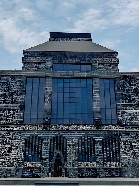 Anahuacalli Museum stone facade with large windows in Mexico City.