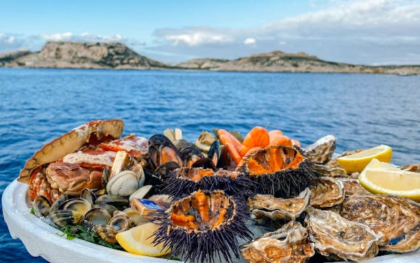 Seafood platter on excursion boat in Calanques de Cassis, France.