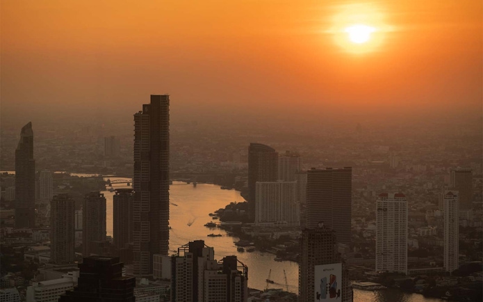 Bangkok skyline view from Mahanakhon SkyWalk at sunset.