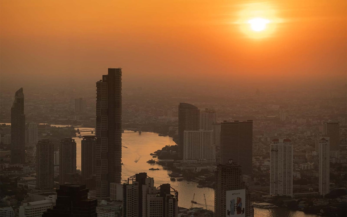 Bangkok skyline view from Mahanakhon SkyWalk at sunset.