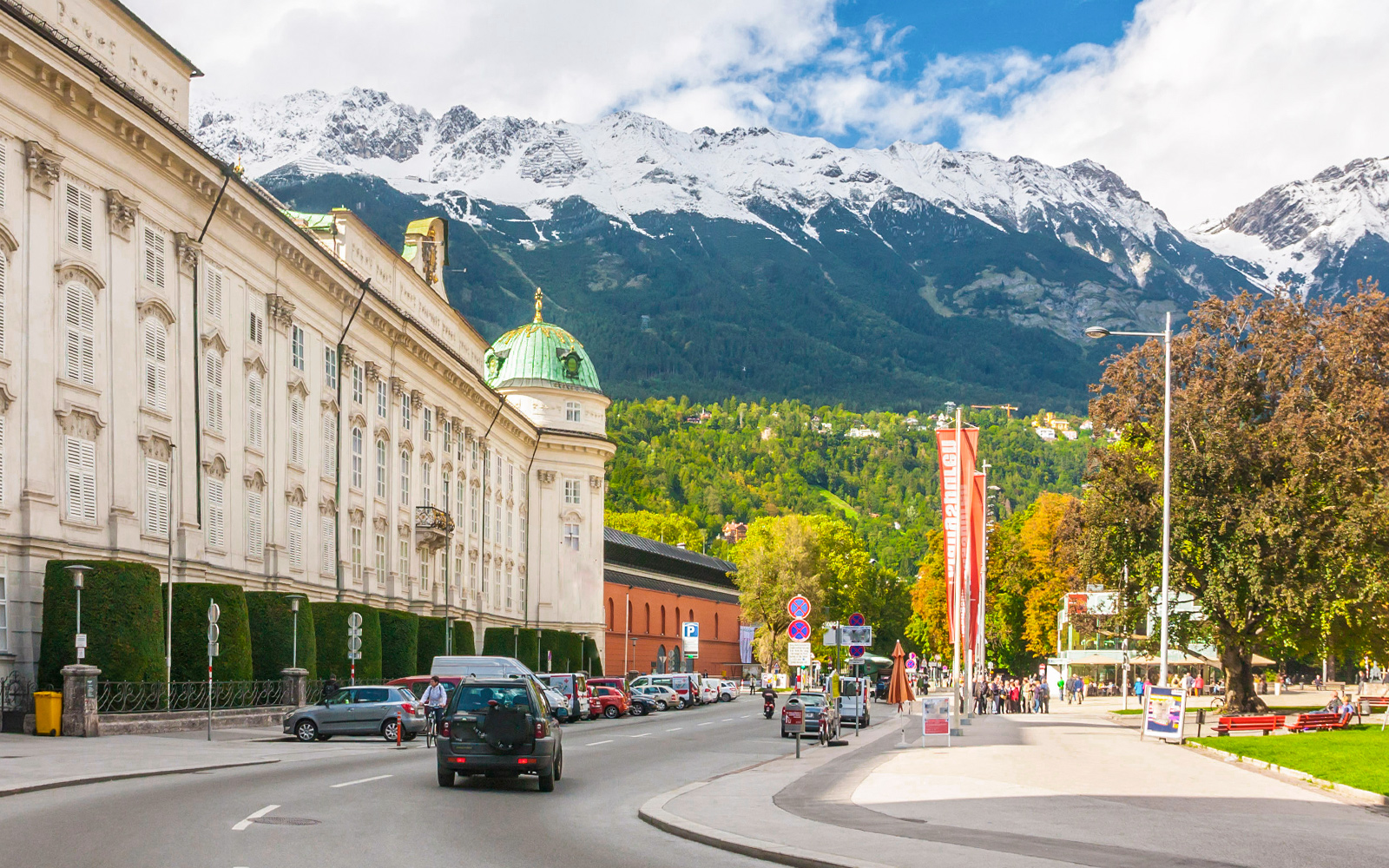 Innsbruck cityscape with snow-capped mountains and winding roads in Austria.