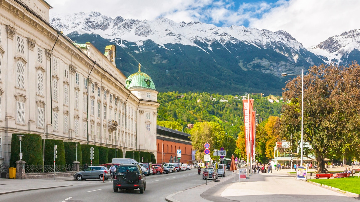 Innsbruck cityscape with snow-capped mountains and winding roads in Austria.