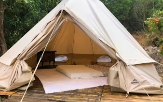 Glamping tent with bed in forest setting, Castiadas, Cagliari.