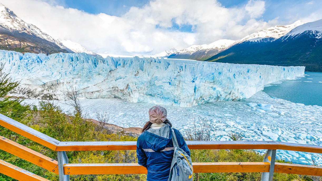 Visitor overlooking Perito Moreno Glacier from viewing deck in Argentina.