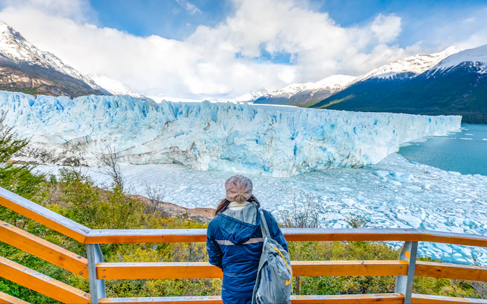 Visitor overlooking Perito Moreno Glacier from viewing deck in Argentina.