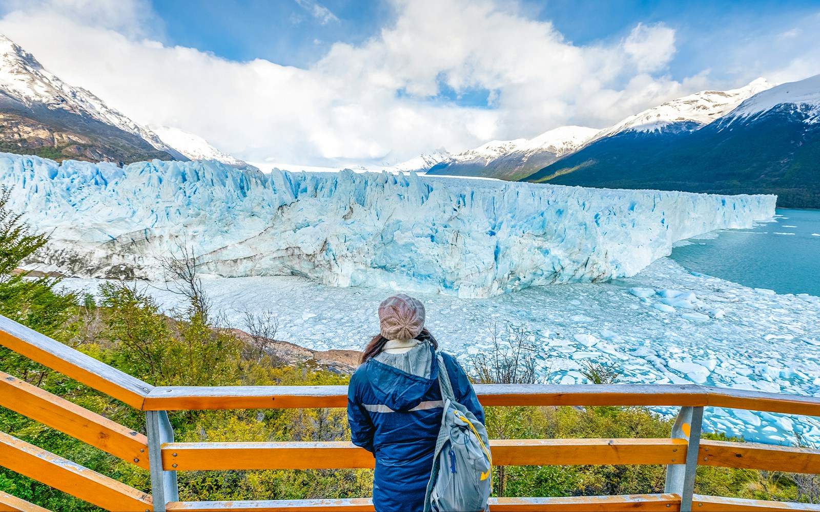 Visitor overlooking Perito Moreno Glacier from viewing deck in Argentina.