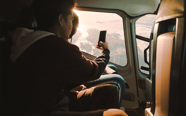 Guests in helicopter viewing Niagara Falls below.