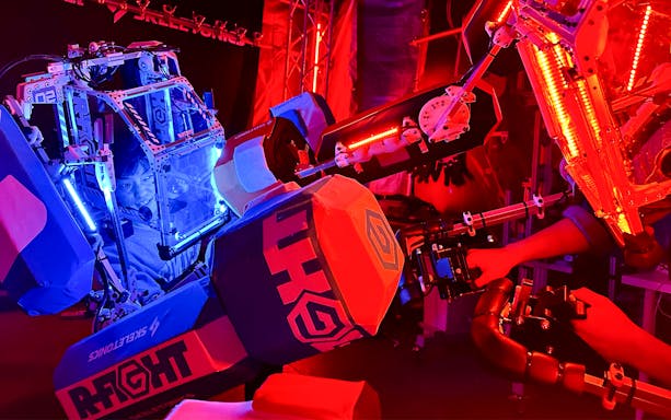 Tourist operating a robot simulator at RED TOKYO TOWER.