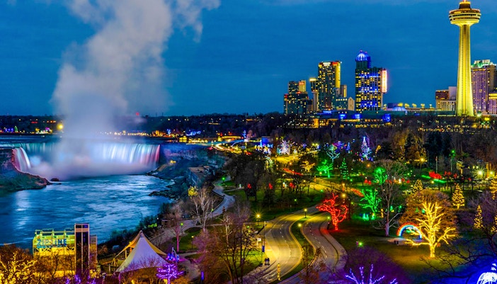 Niagara Falls illuminated at night during the Festival of Lights, view from Journey Behind the Falls tour.