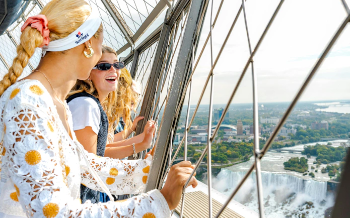 Visitors enjoying the view of Niagara Falls from an observation deck, Canada.