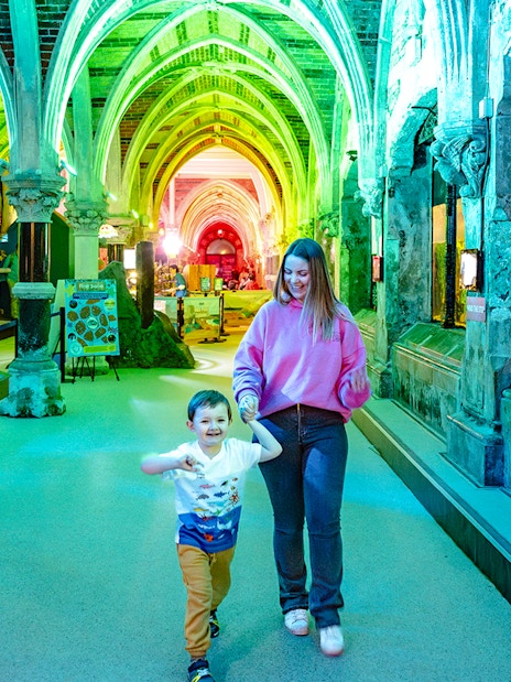 Guests exploring SEA Life Brighton's illuminated aquarium corridor.