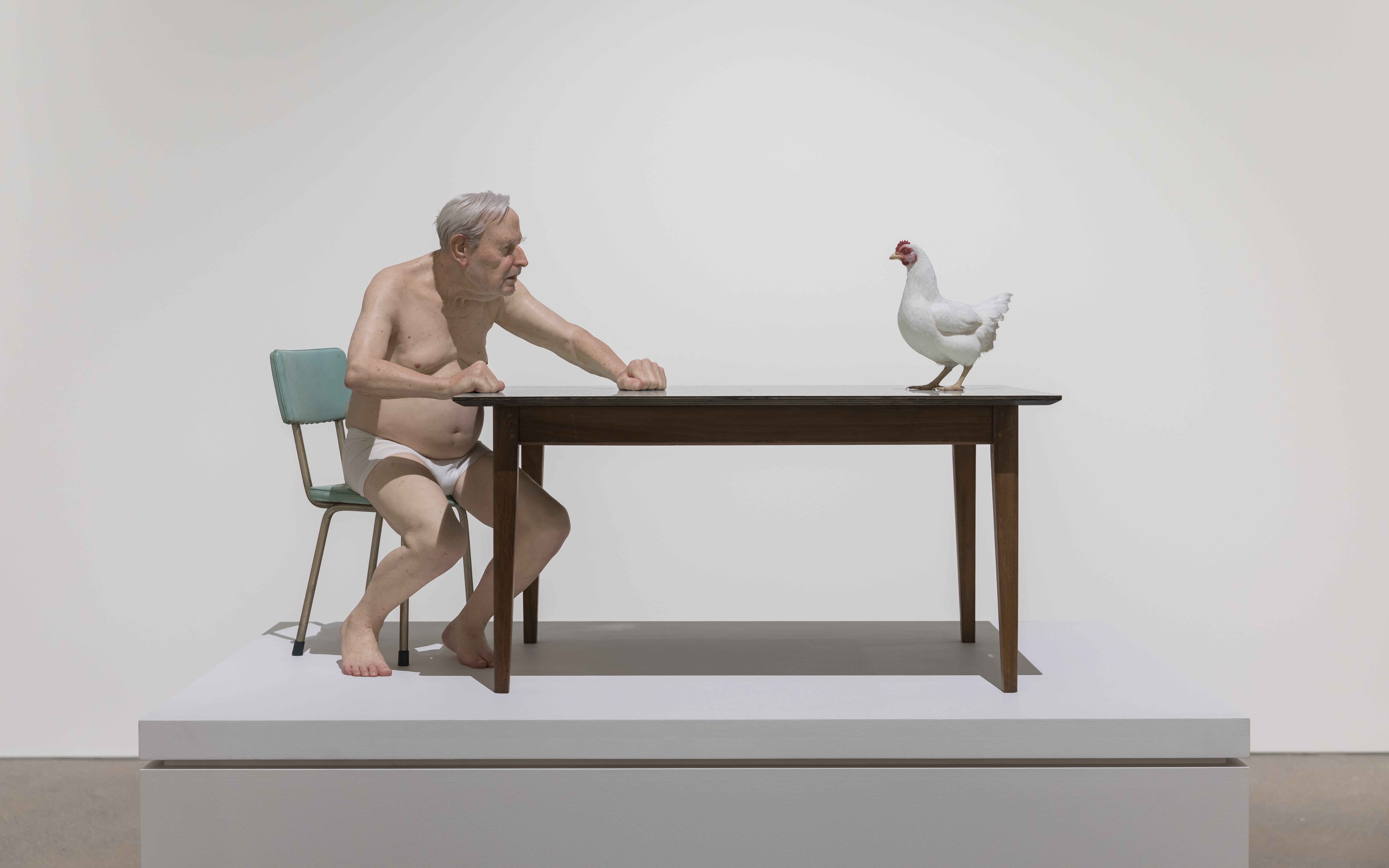 Man and chicken sculpture by Ron Mueck at Art Gallery of New South Wales, Sydney.