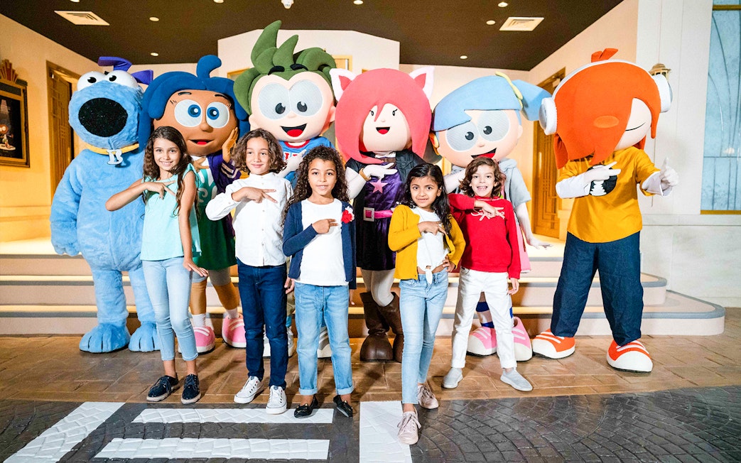 Children posing with KidZania mascots in Dubai.