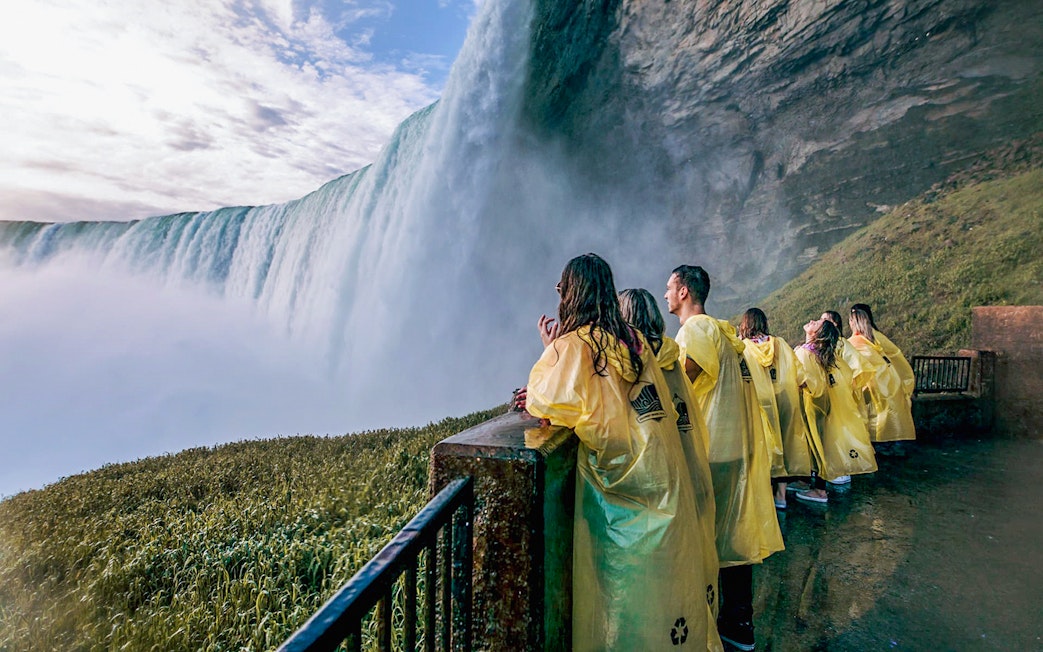 Visitors in yellow ponchos at a Niagara Falls viewpoint.