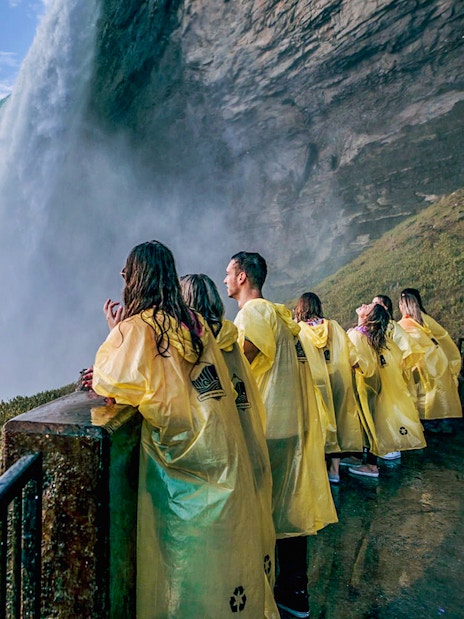 Visitors in yellow ponchos at a Niagara Falls viewpoint.
