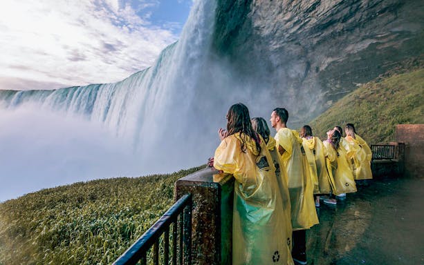 Visitors in yellow ponchos at a Niagara Falls viewpoint.