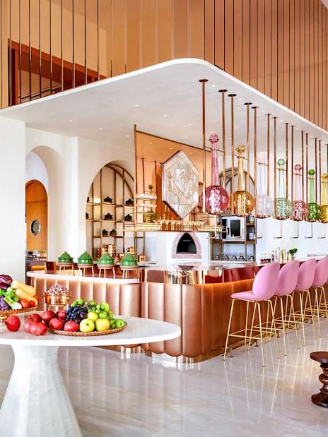 Dining area of Arianas Persian Kitchen with colorful decor and fresh produce display.