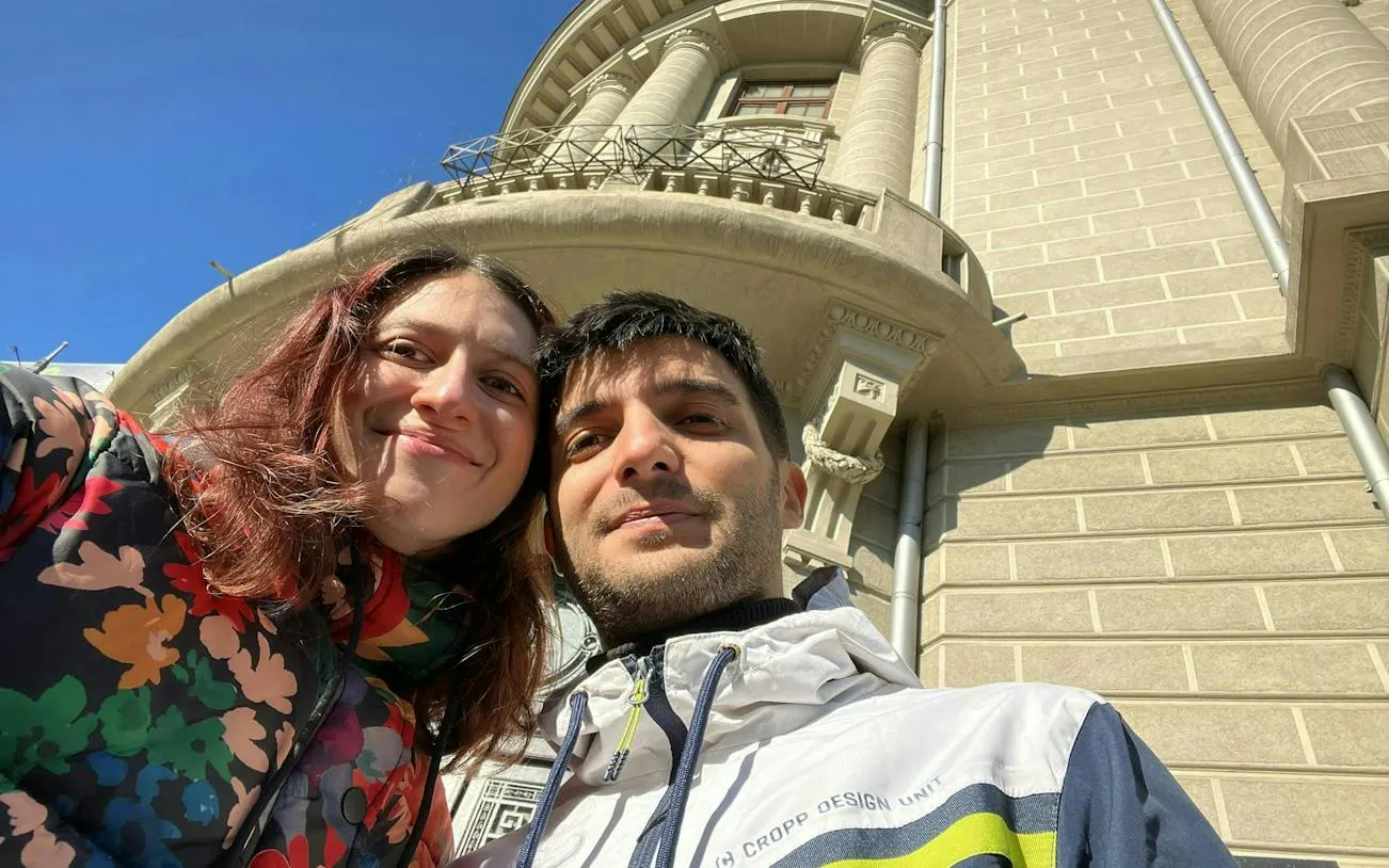 Couple exploring historic architecture in Bucharest during self-guided city game.