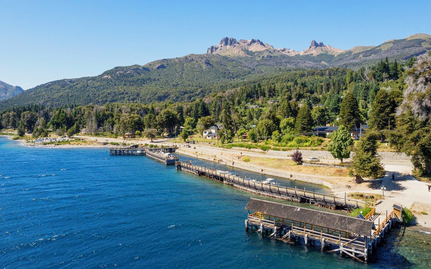 Aerial view of Villa La Angostura shoreline and harbor with mountains in the background.