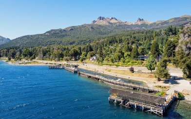 Aerial view of Villa La Angostura shoreline and harbor with mountains in the background.