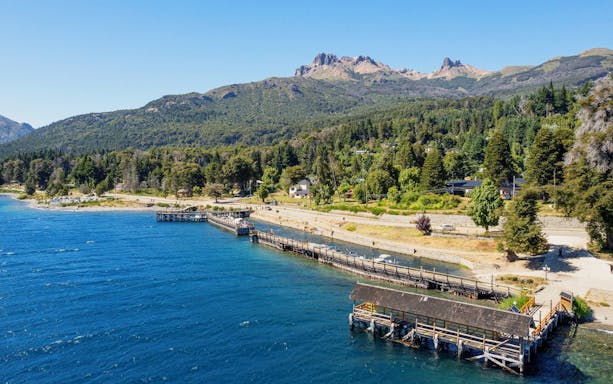 Aerial view of Villa La Angostura shoreline and harbor with mountains in the background.