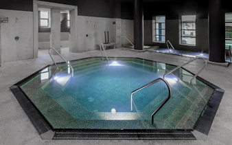Indoor pool at Pesterzsebet Bath, Budapest with steps and handrails.