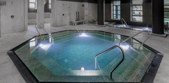 Indoor pool at Pesterzsebet Bath, Budapest with steps and handrails.