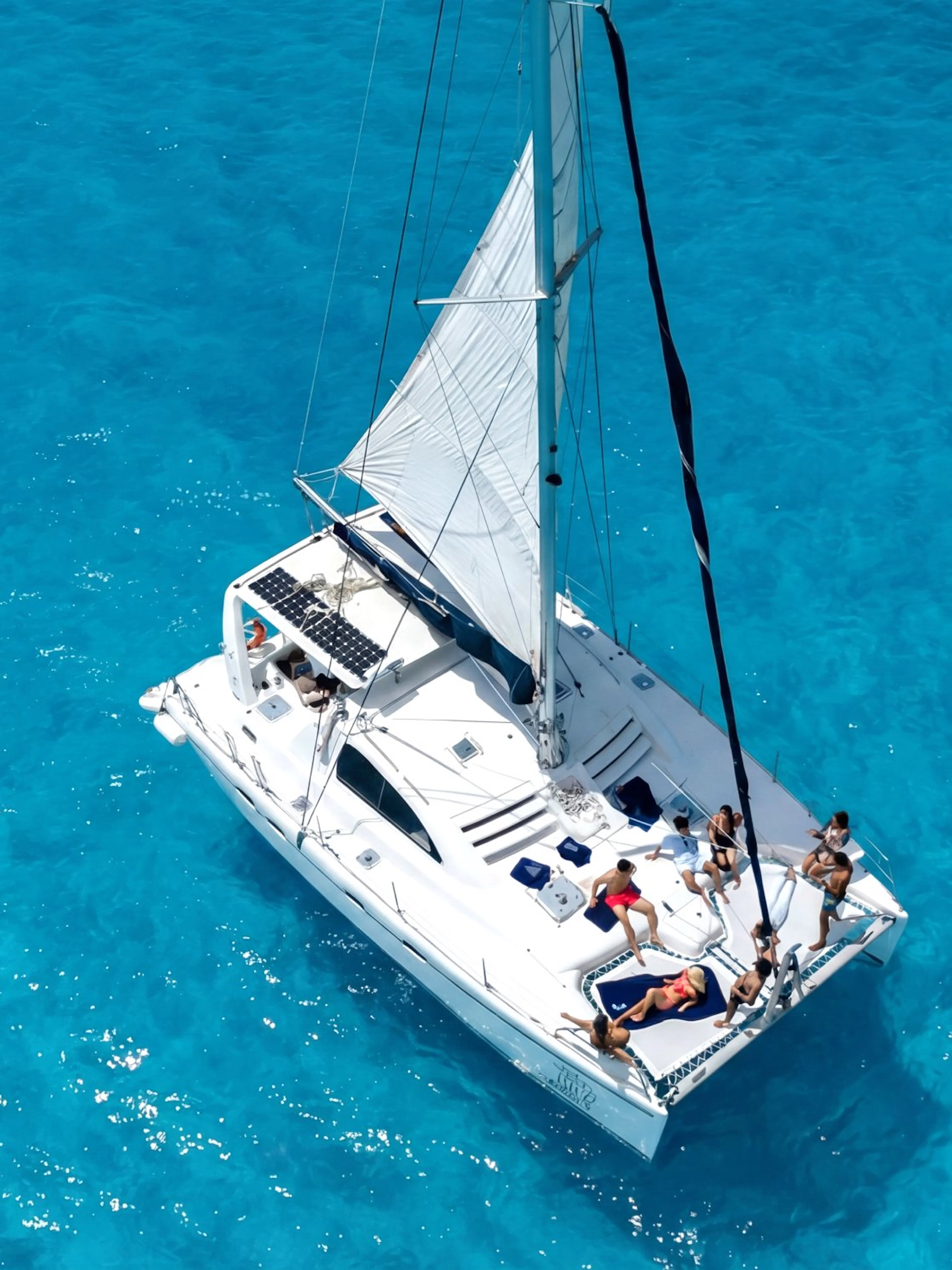 Catamaran sailing on clear blue waters near Isla Mujeres.