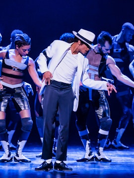 Dancers performing on stage in a jukebox musical show.