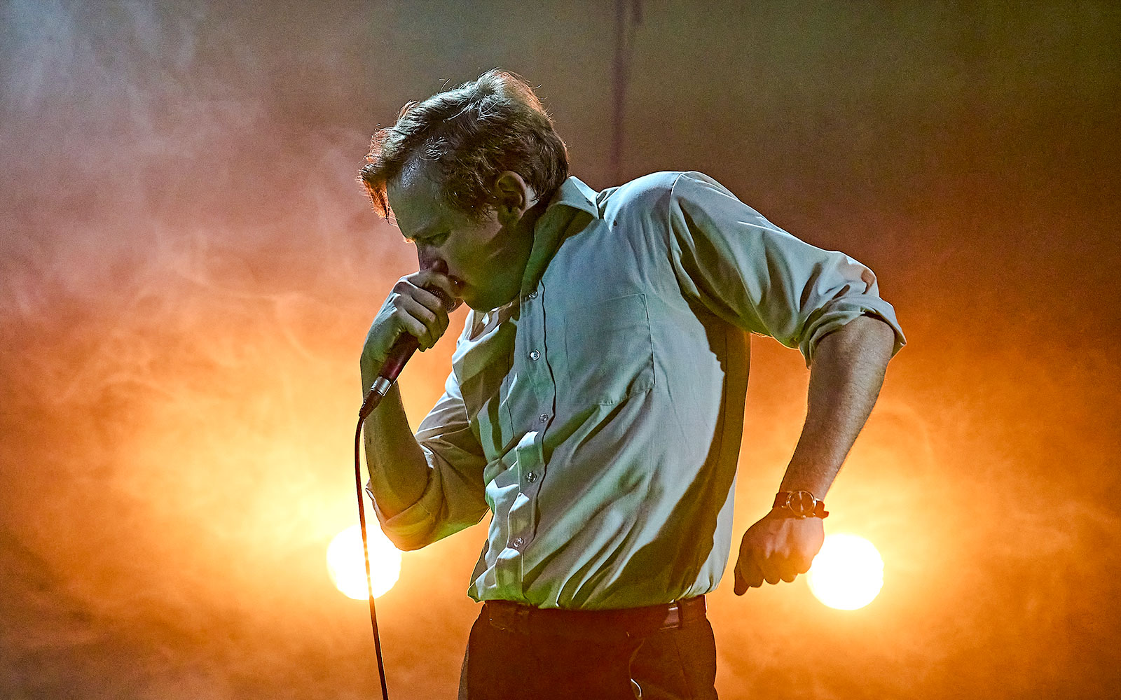 Performer on stage during Kenrex show with dramatic lighting.