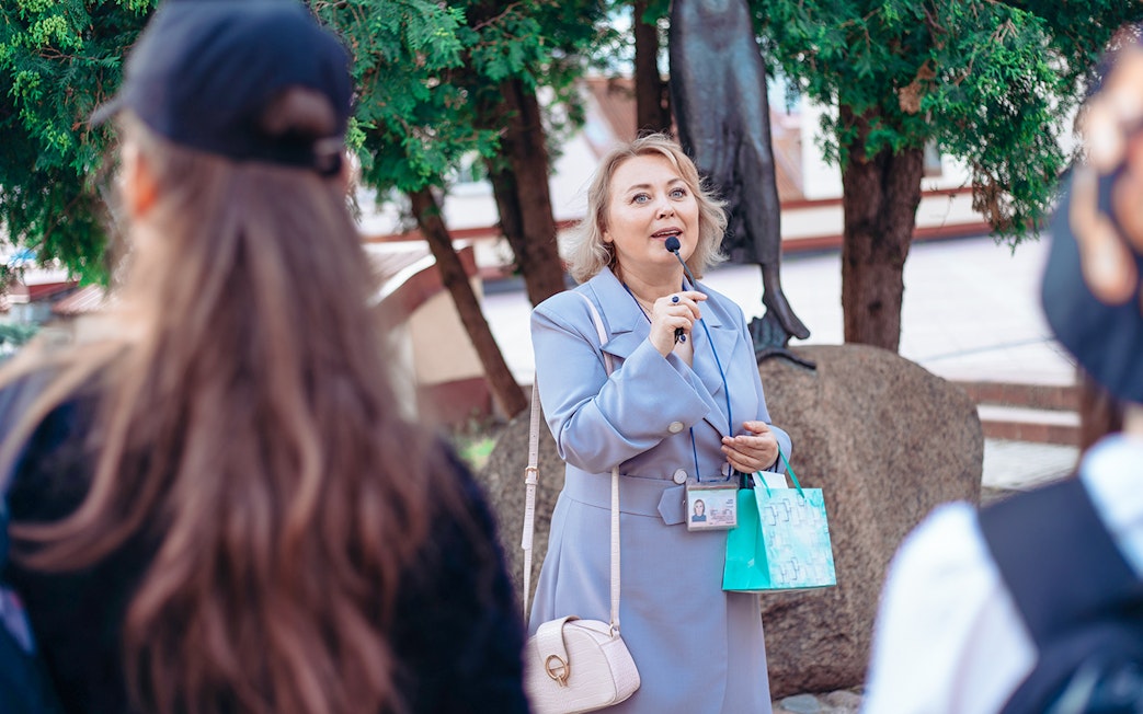 Guide briefing group at Palace of Versailles.