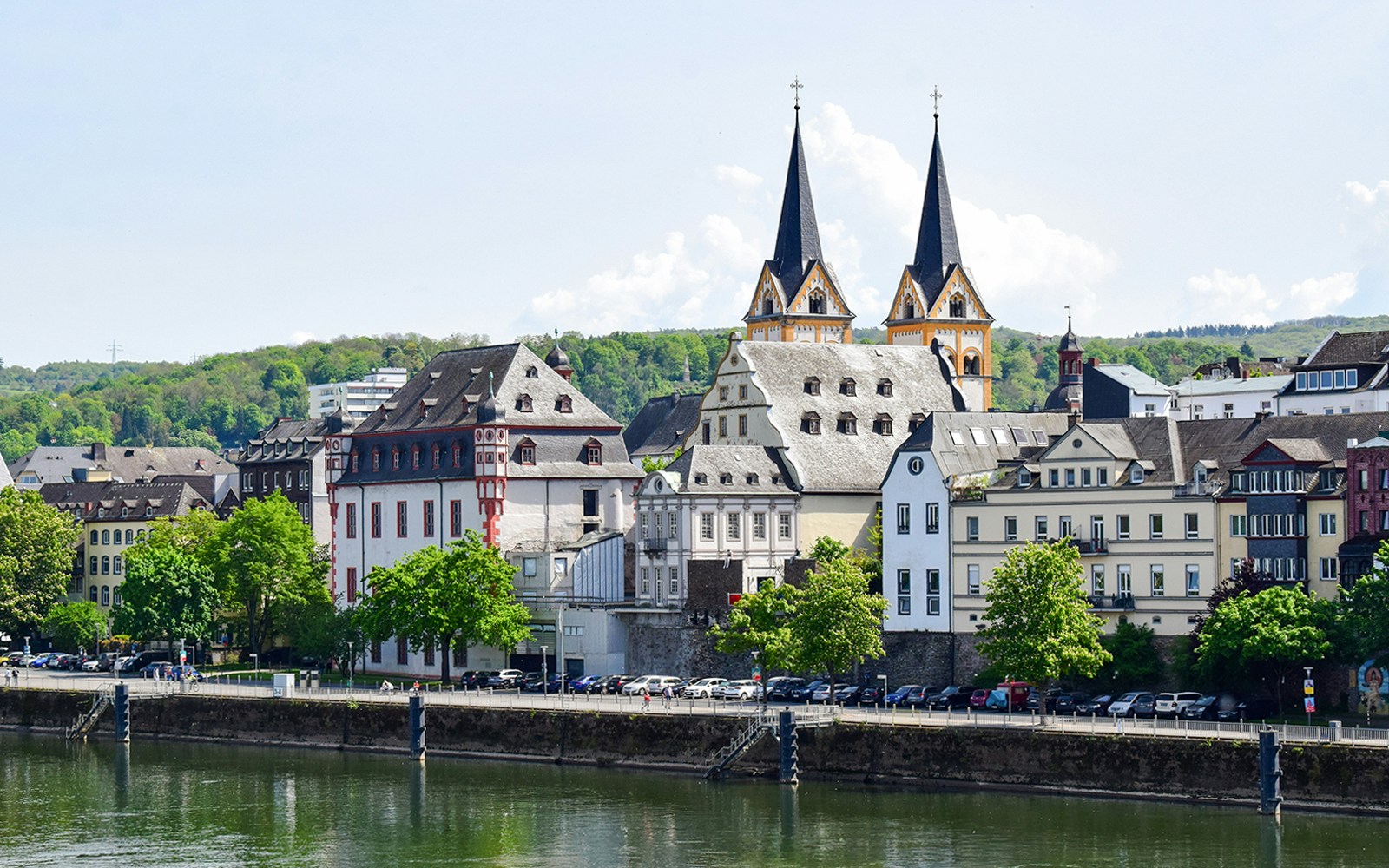 Koblenz old town view from Mosel river with historic buildings and church spires.