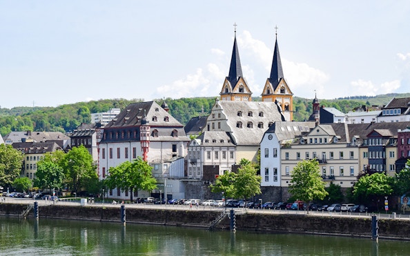 Koblenz old town view from Mosel river with historic buildings and church spires.