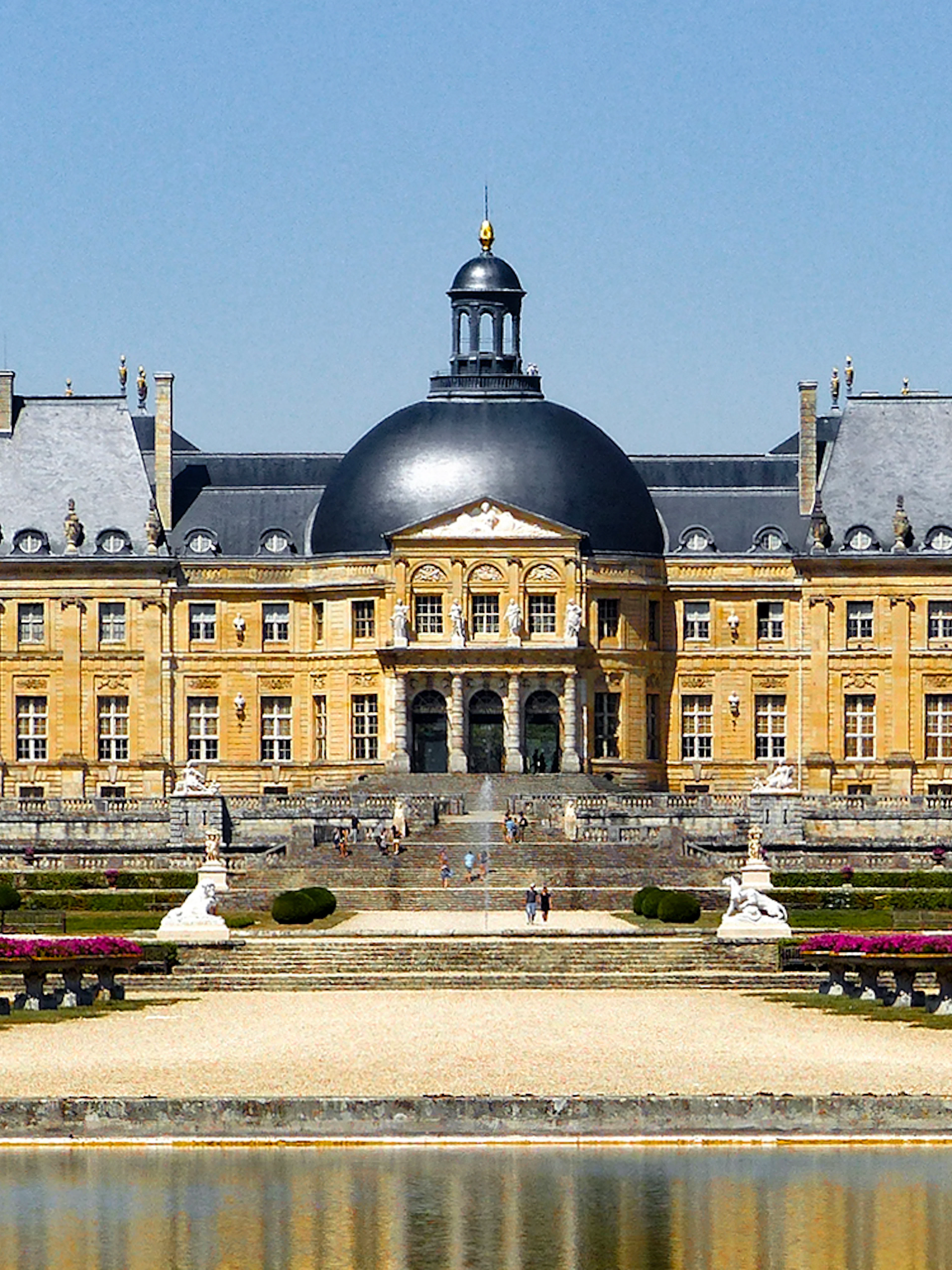 Château of Vaux-le-Vicomte with gardens and reflecting pool in France.