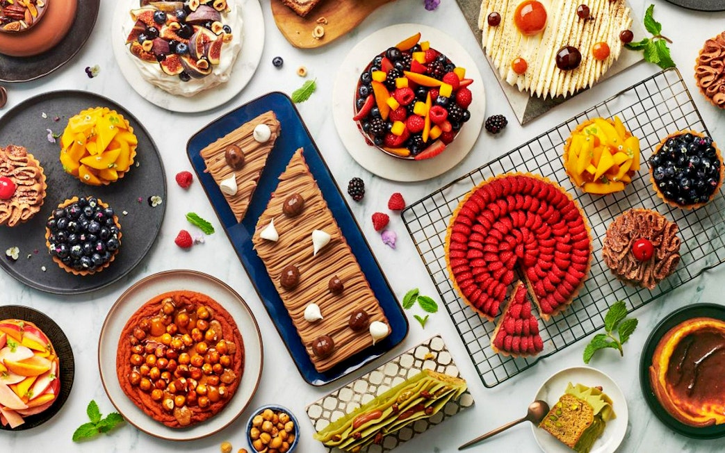 Assorted desserts at Gastronomy Buffet Dinner Experience, Dubai, featuring cakes, tarts, and pastries.
