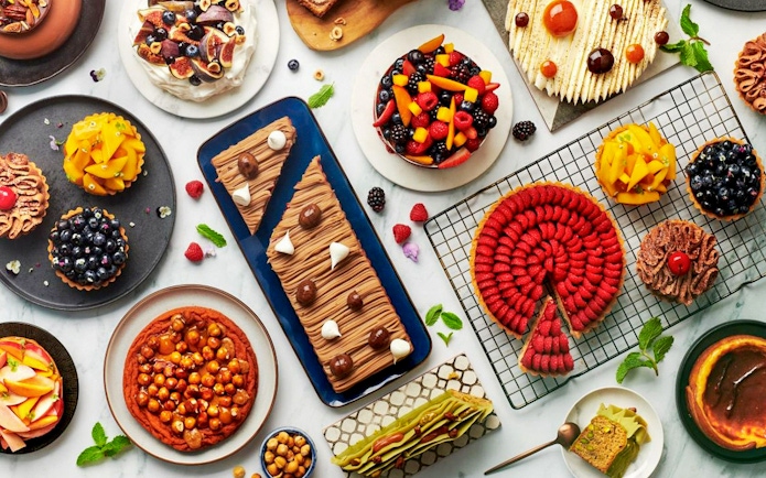 Assorted desserts at Gastronomy Buffet Dinner Experience, Dubai, featuring cakes, tarts, and pastries.