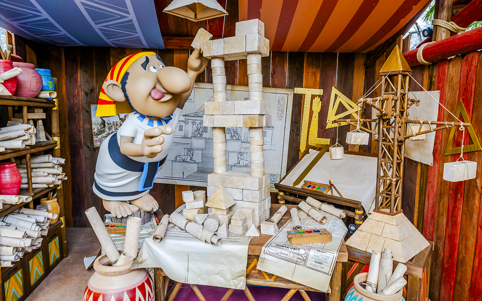 Cartoon character building a stone structure at Parc Asterix.