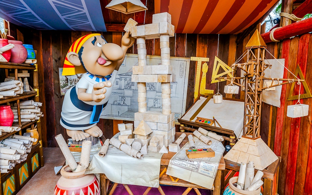 Cartoon character building a stone structure at Parc Asterix.