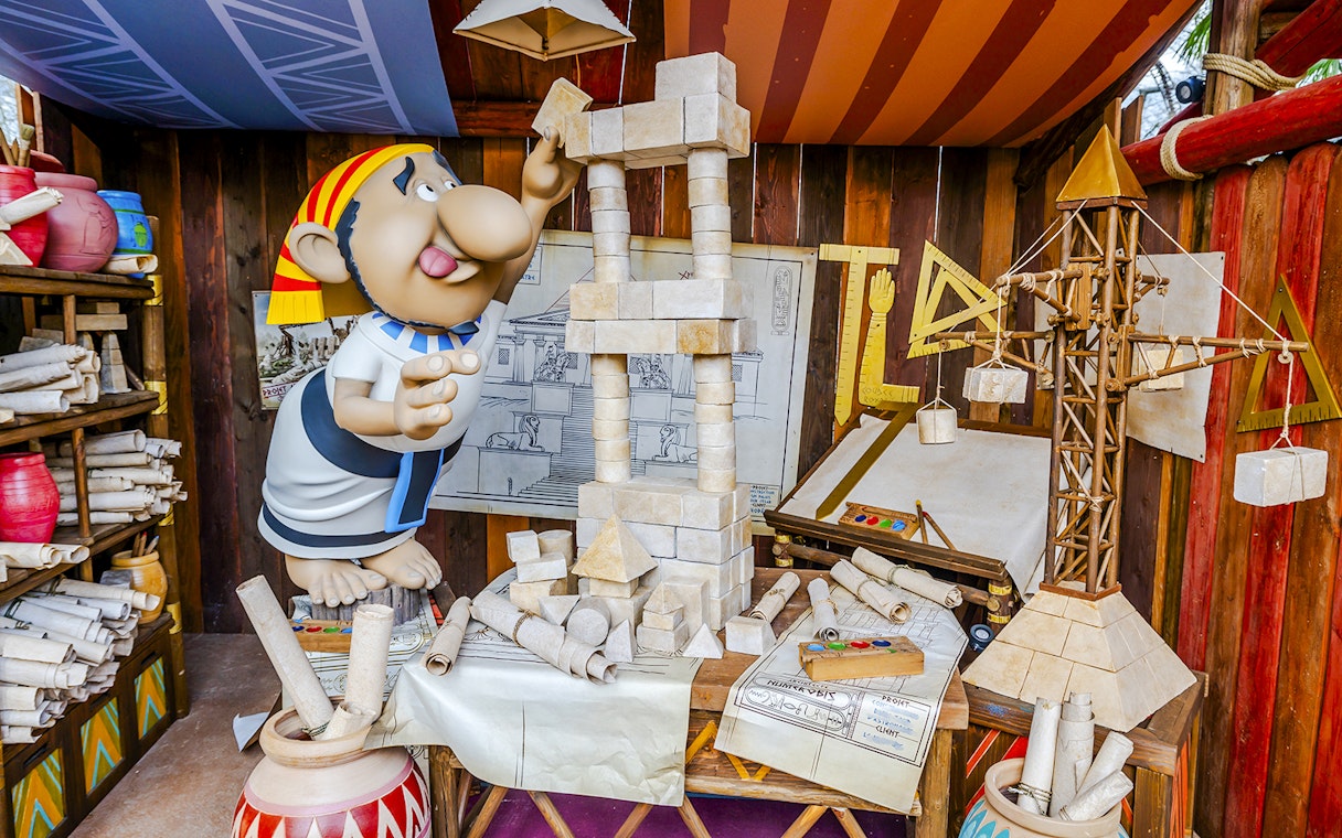 Cartoon character building a stone structure at Parc Asterix.