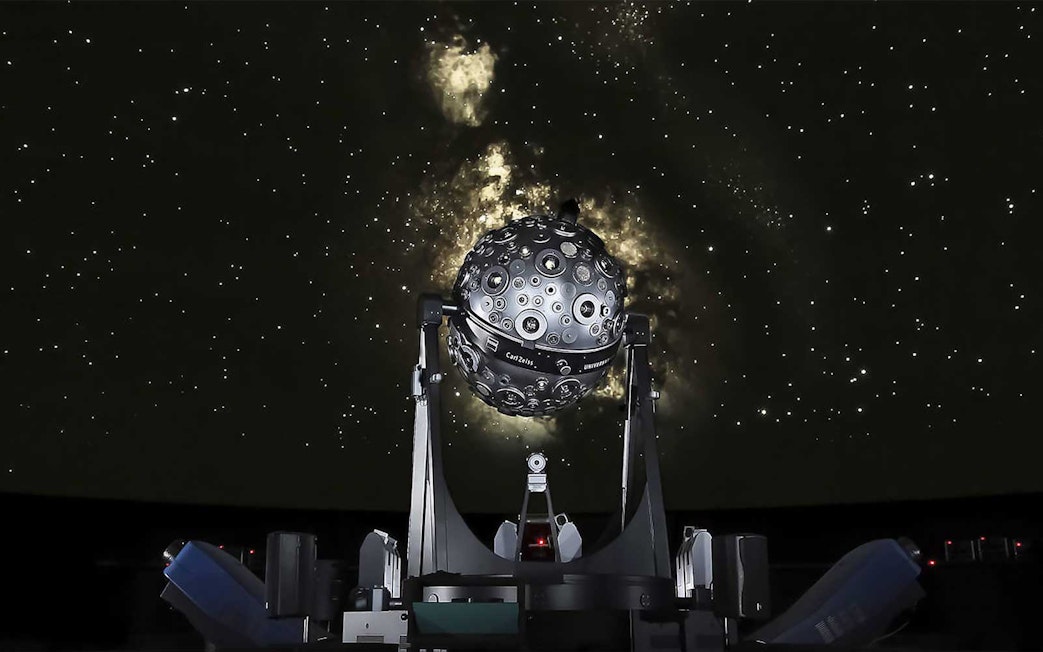 Planetarium projector under a starry sky at Lisbon Navy Planetarium.