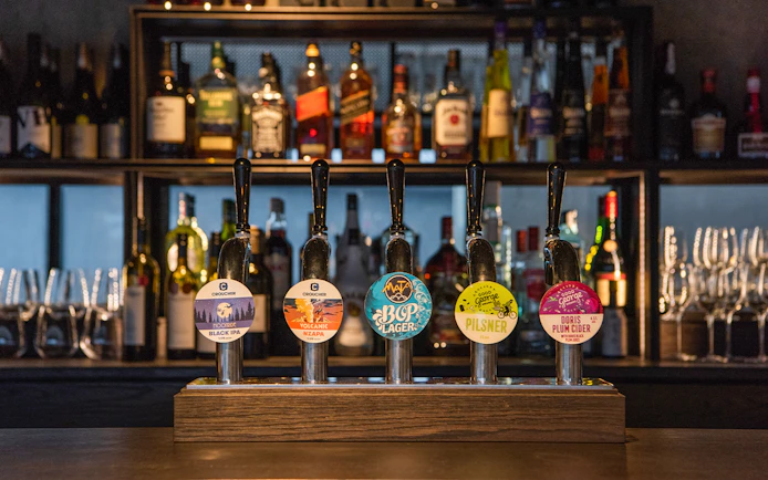 Bar with various beer taps at Te Puia's Hāngī Buffet Dinner in Rotorua, New Zealand.