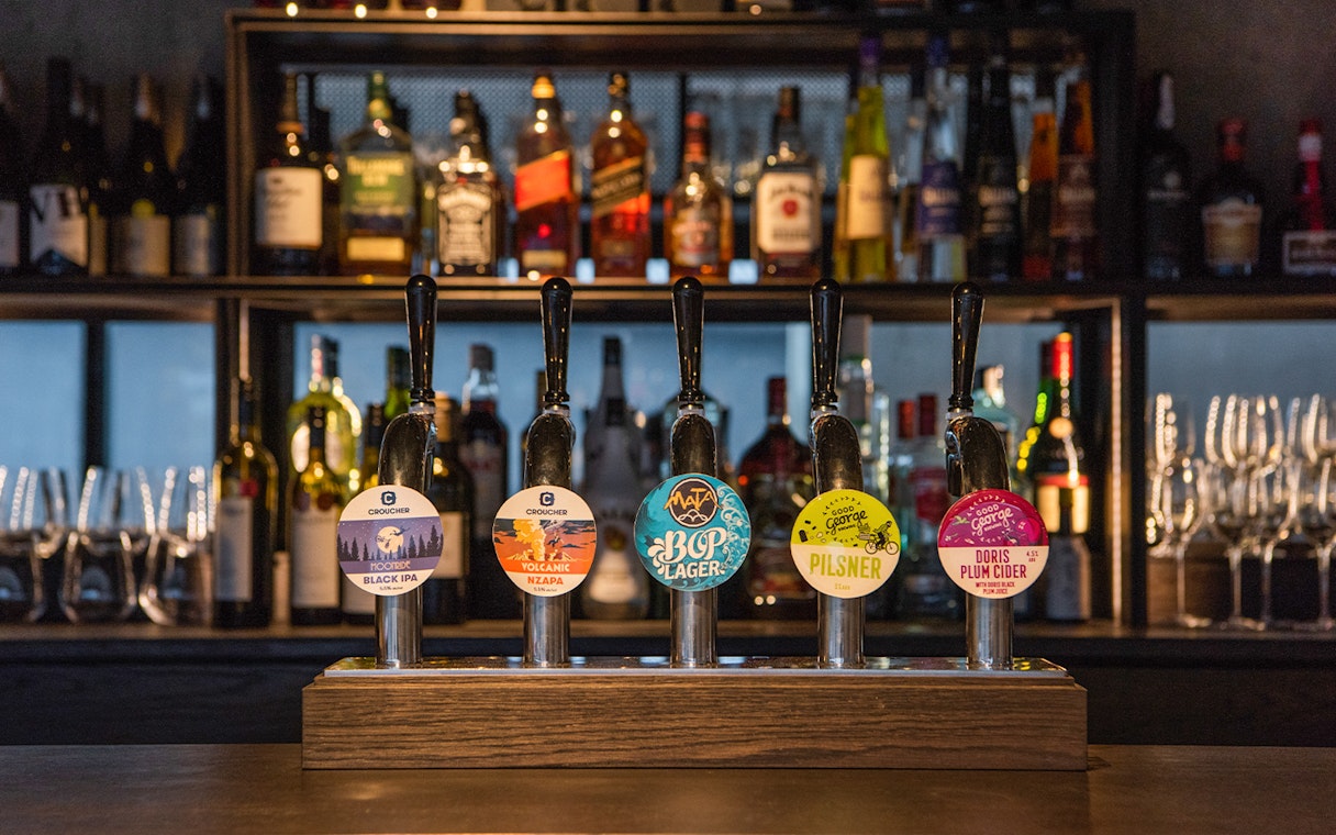 Bar with various beer taps at Te Puia's Hāngī Buffet Dinner in Rotorua, New Zealand.