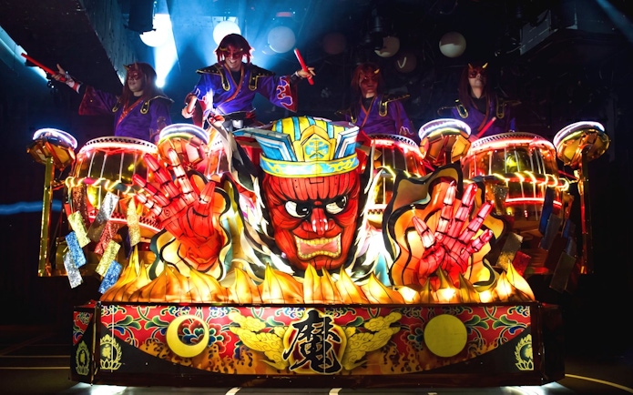 Samurai performers in vibrant costumes on illuminated float, Kabukicho, Shinjuku, Tokyo.