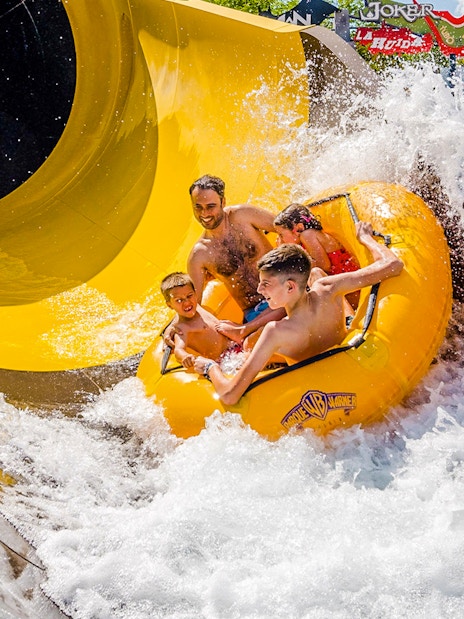 Group enjoying water slide at Parque Warner Beach, Madrid.