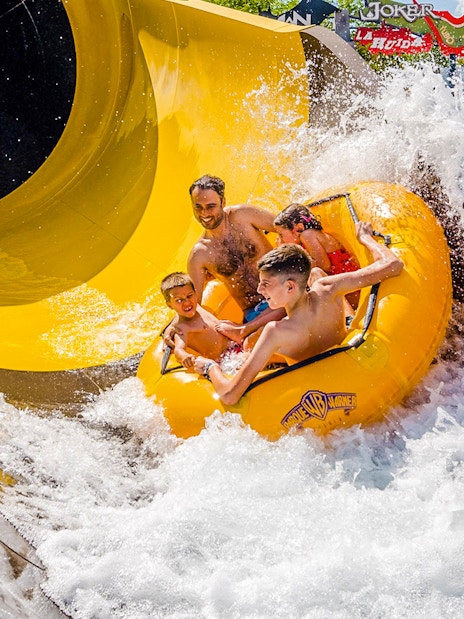 Group enjoying water slide at Parque Warner Beach, Madrid.