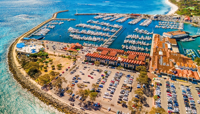 Aerial view of Hillarys Boat Harbour marina with yachts and waterfront buildings, Australia.